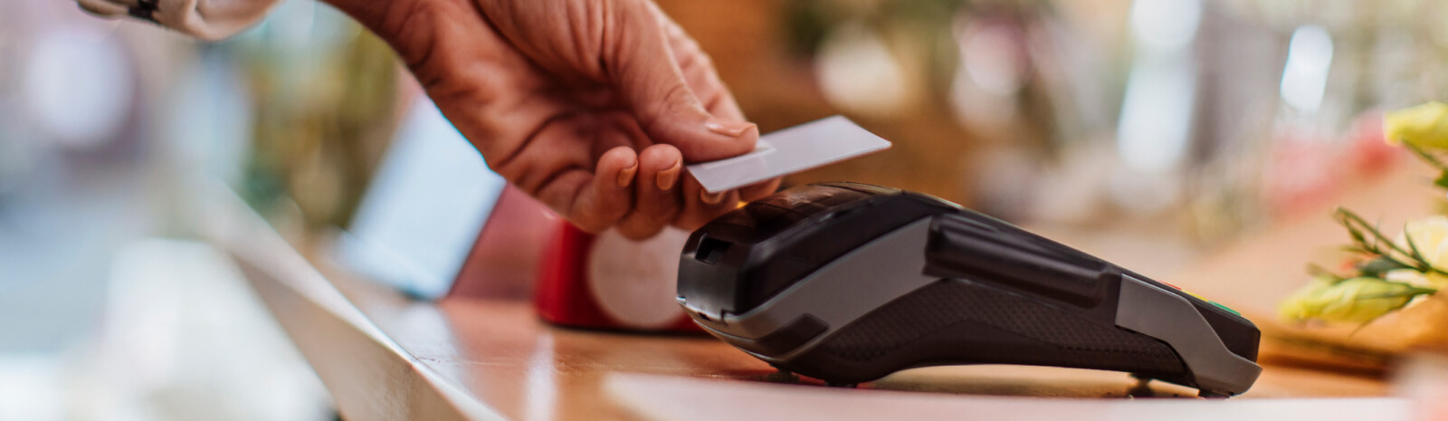 Close up of someone's hand using a card reader