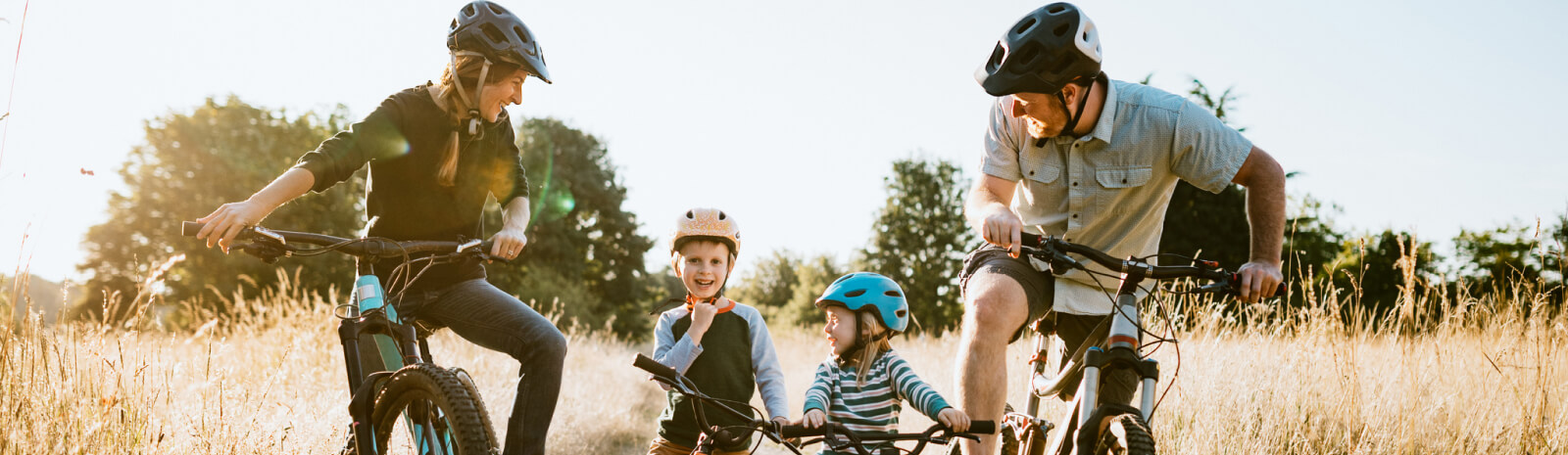 A young family on bikes in a field