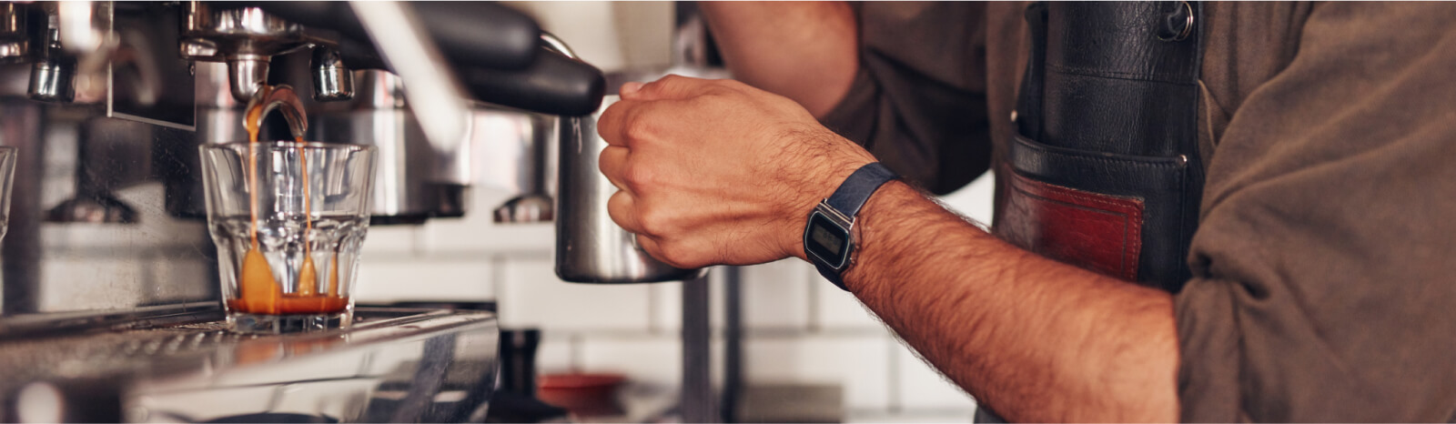 Close up of a person making a cup of espresso