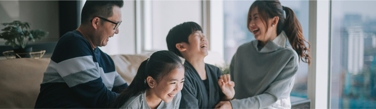 A young family playing together inside