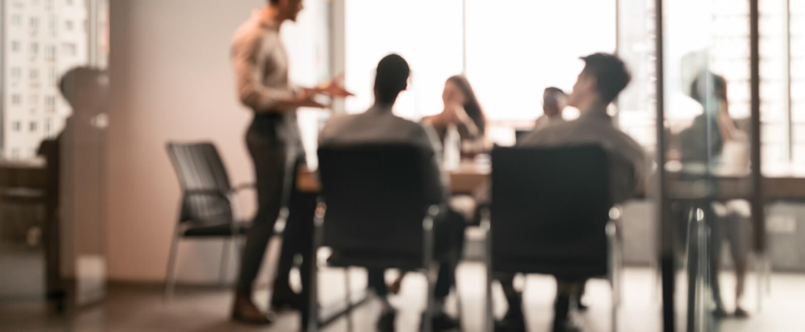 Out-of-focus shot of a group of people in a business meeting