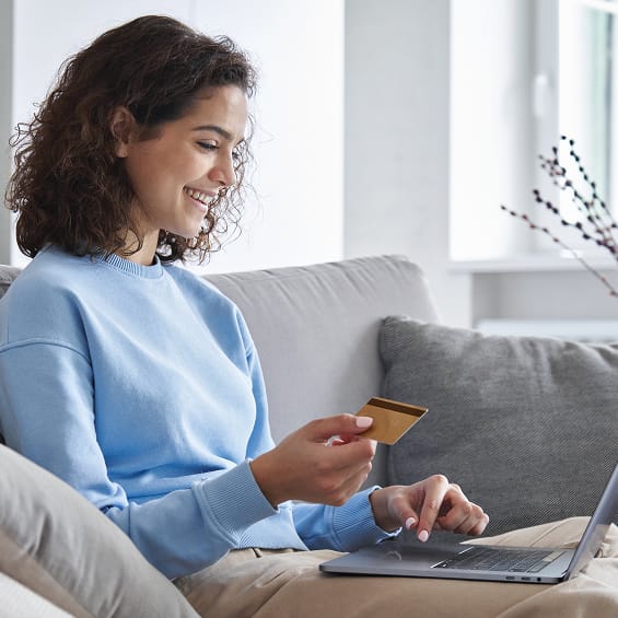 Online banking concept: a woman with a laptop and credit card