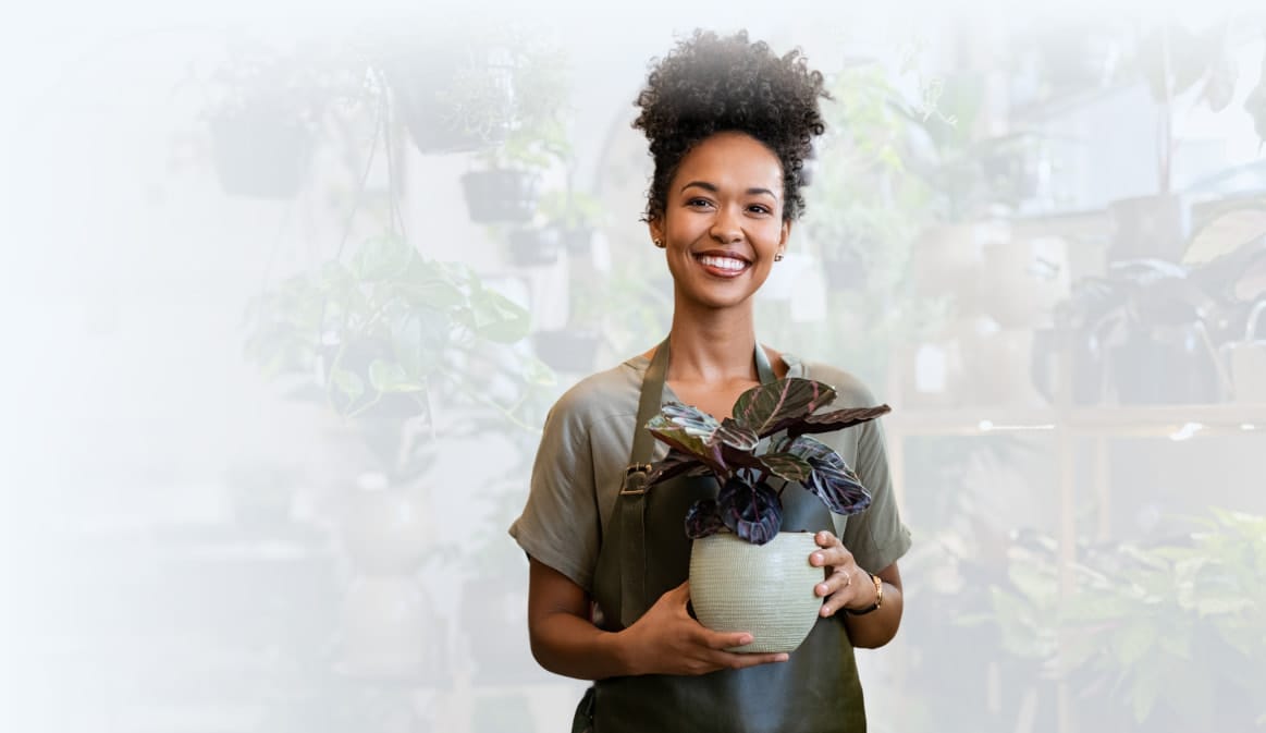 A woman holding a plant