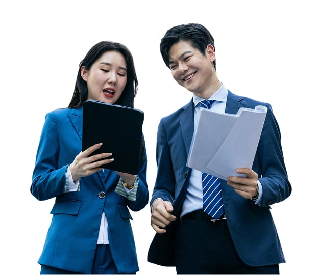 a business woman and business man in professional attire reviewing documents